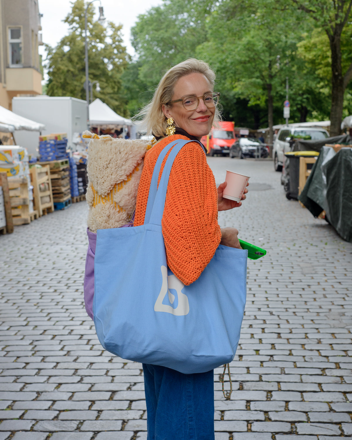 Blue canvas tote bag with Berberlin logo in orange and white.